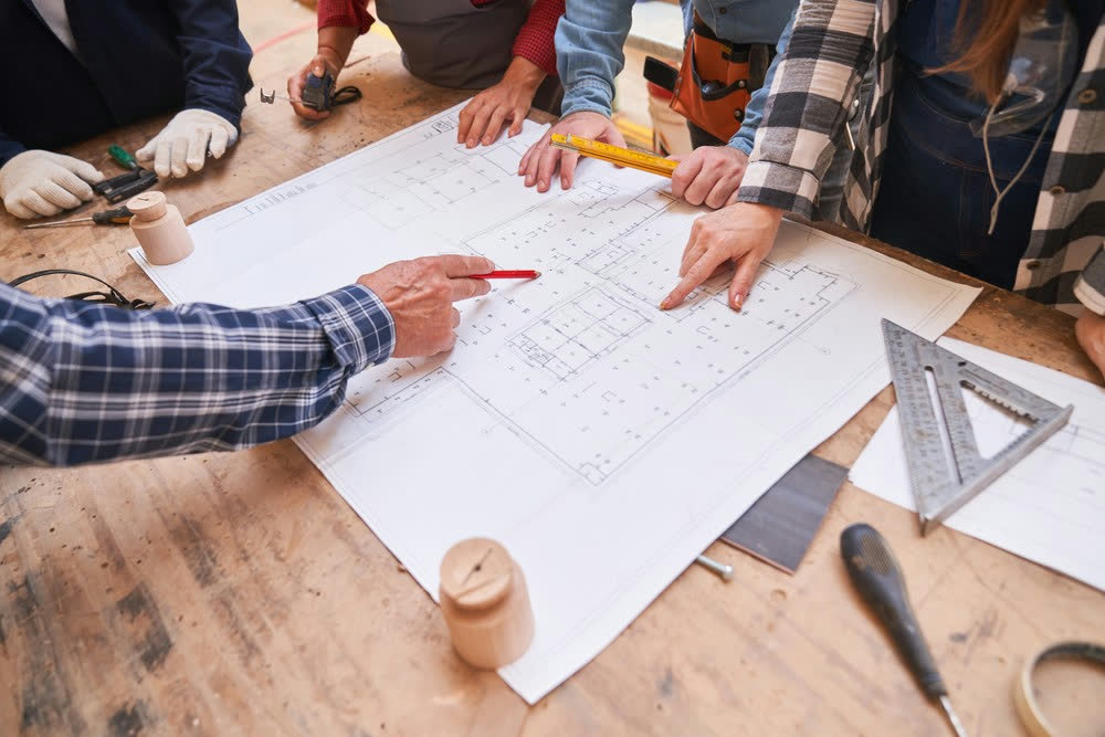 Engineers working on blueprints