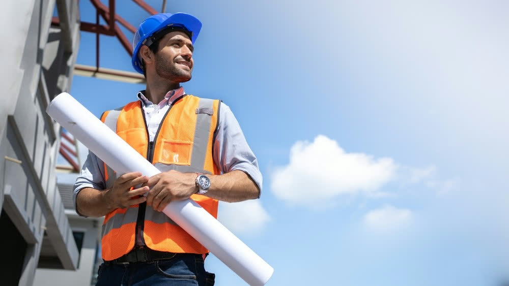Construction worker with blueprints
